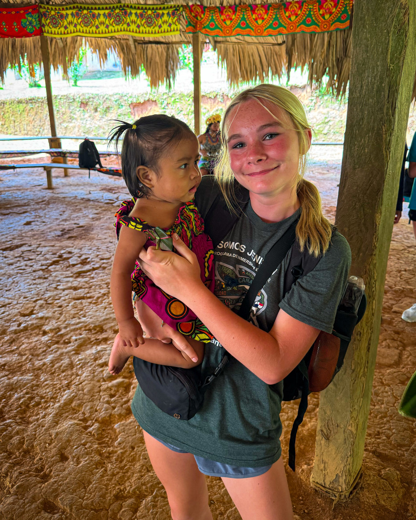 Junior high student holds young child