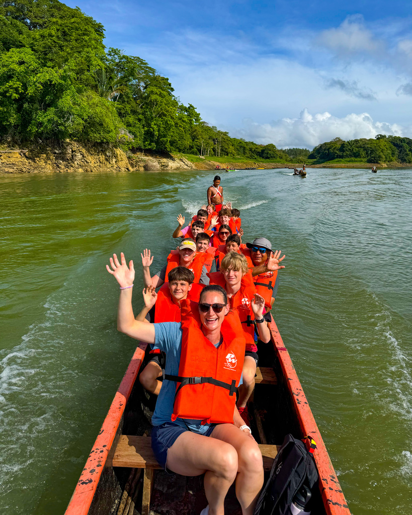 Junior high students waving from boat