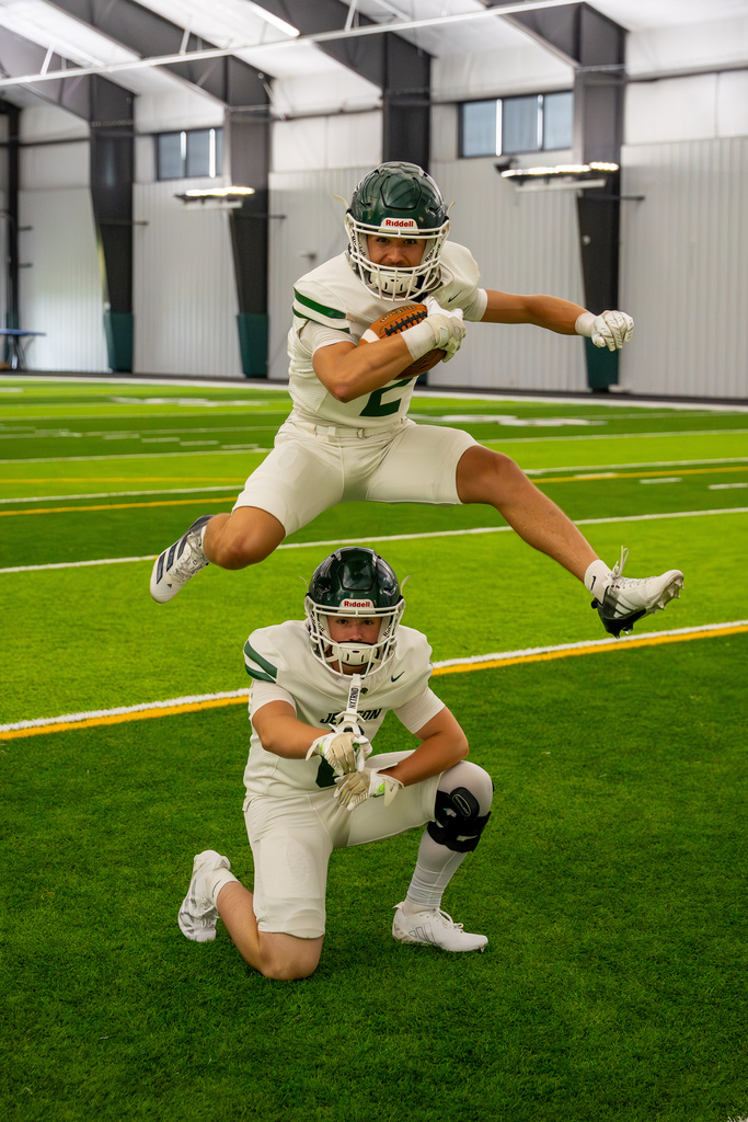 Football team members jumping over each other