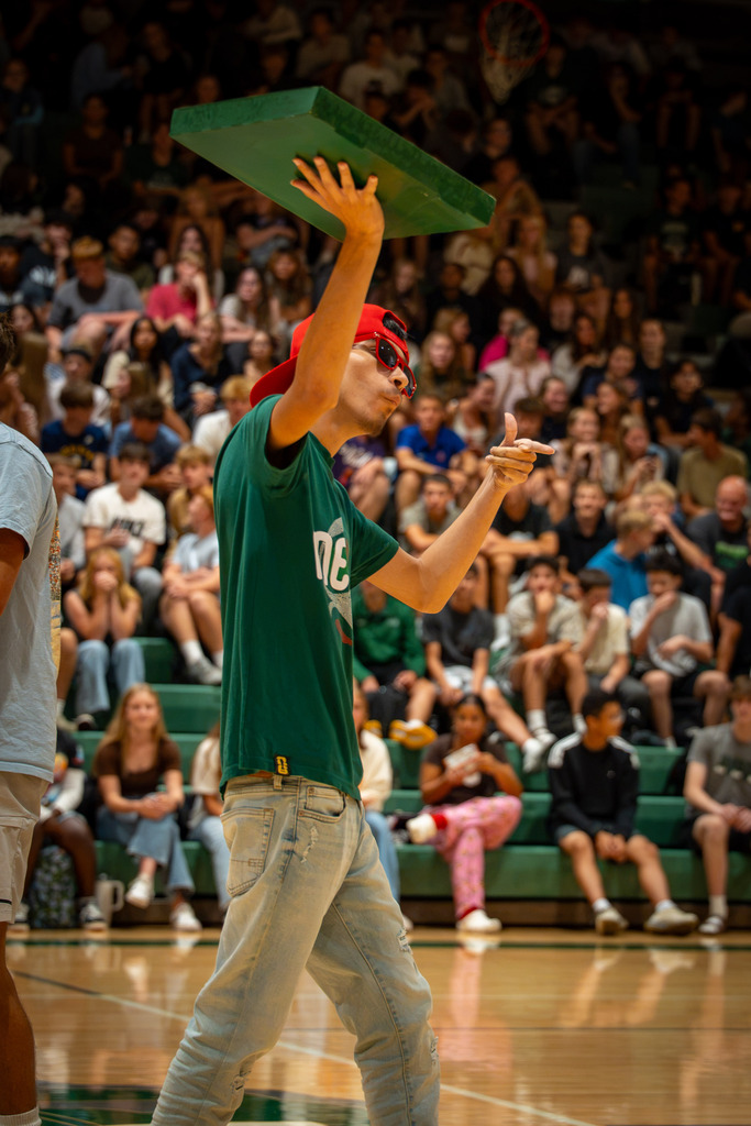Student carrying pizza box at rally