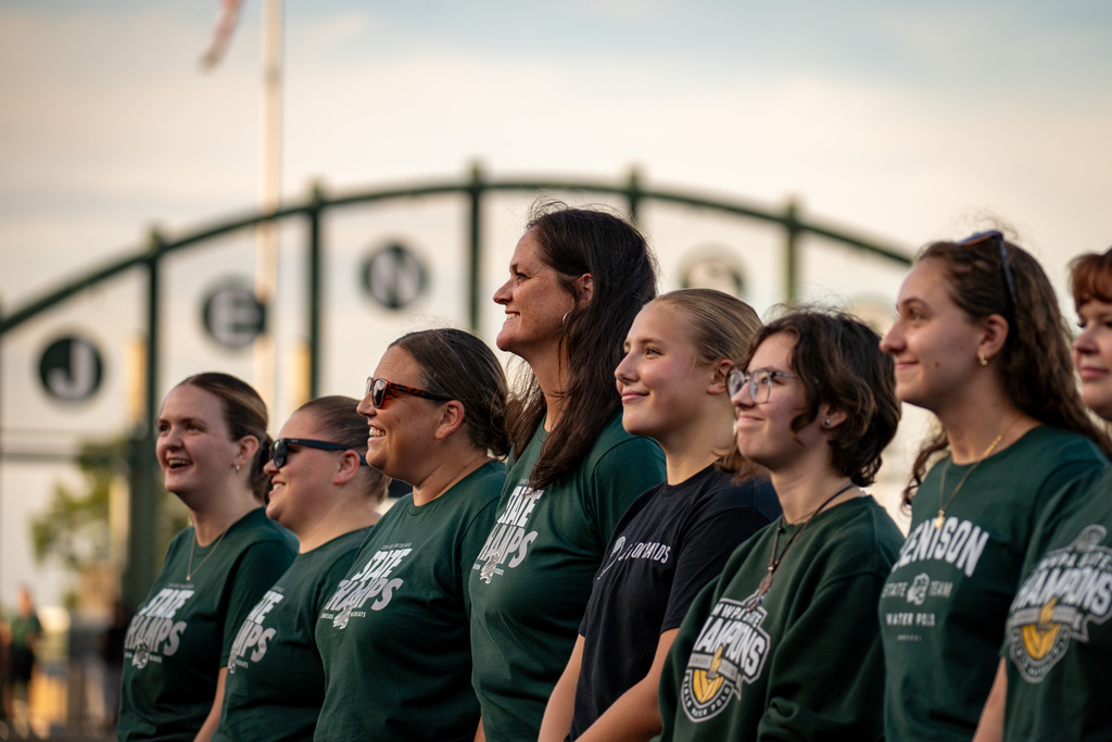 Girls water polo team smiling during ceremony