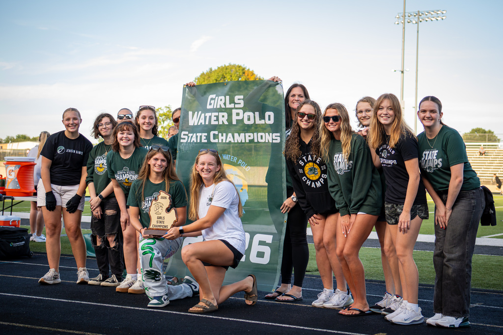 Girls water polo team holding trophy