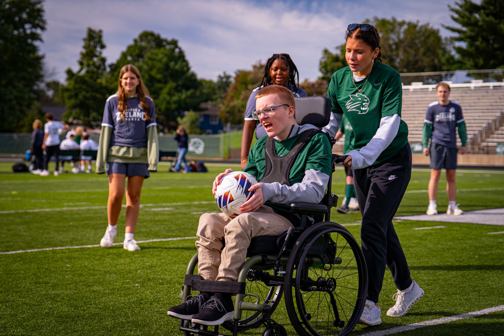 Student in wheelchair with soccer ball