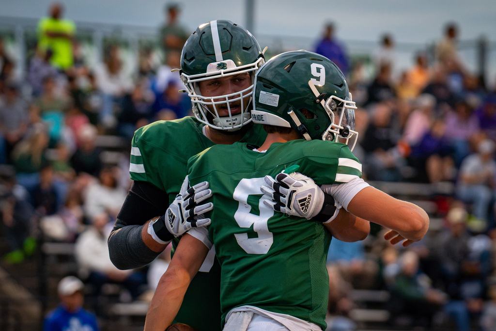 Quarterback and lineman celebrating touchdown