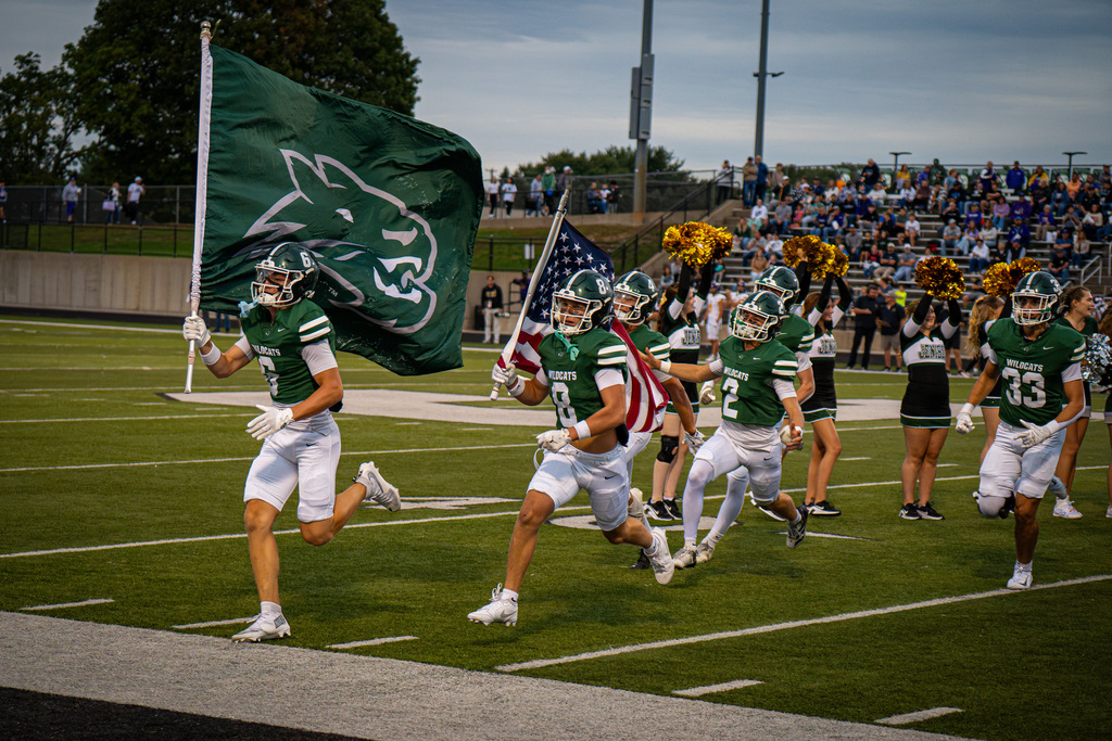 Football team running with flag