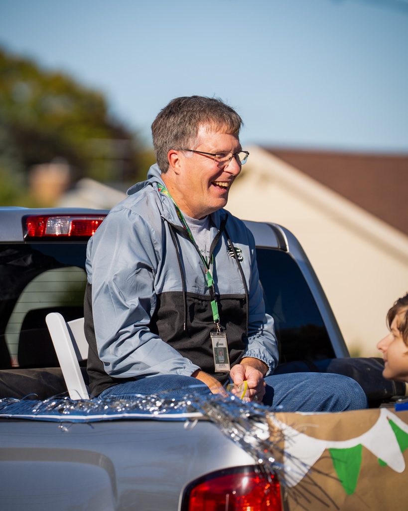 Grand marshal smiling from truck in parade