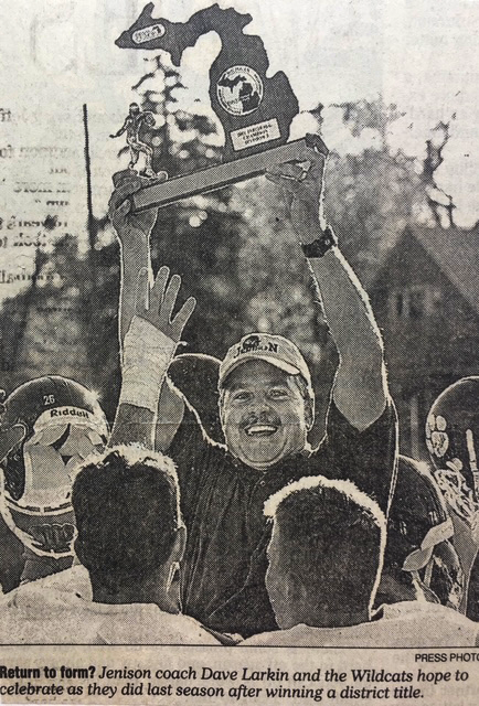 Coach holding trophy