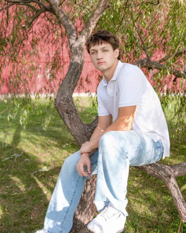 Salutatorian posing on tree