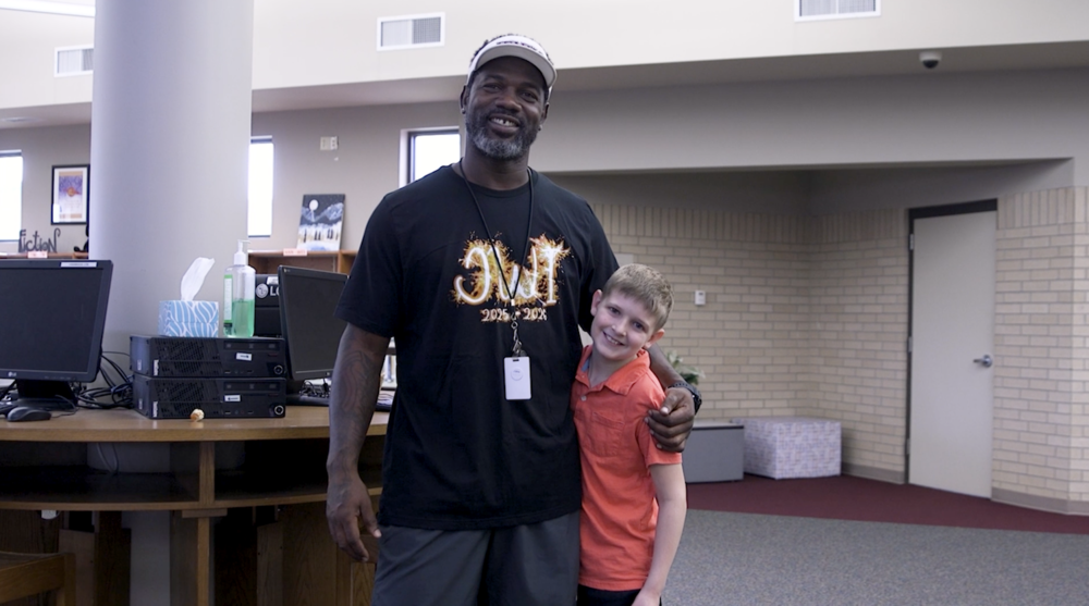 Coach Willie Ponder smiling with Michael, a 5th grade student at Jenks West Intermediate