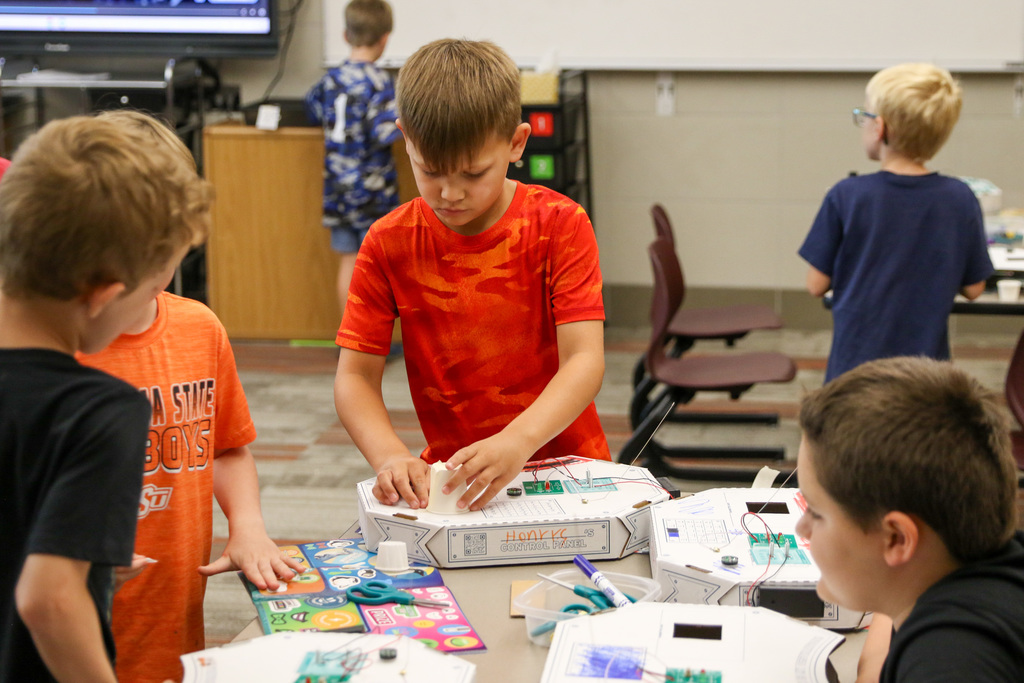 boy taping things to his control panel