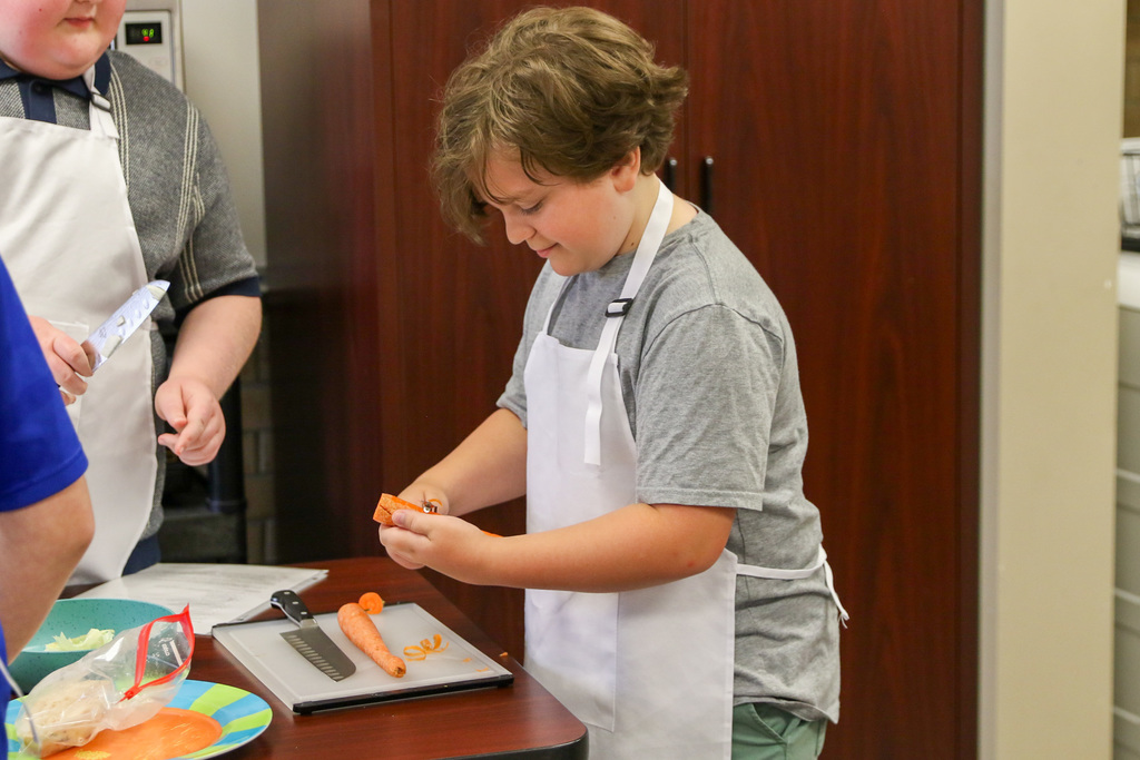 boy peeling carrot