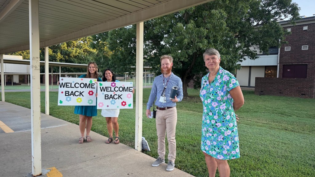 staff members with welcome sign