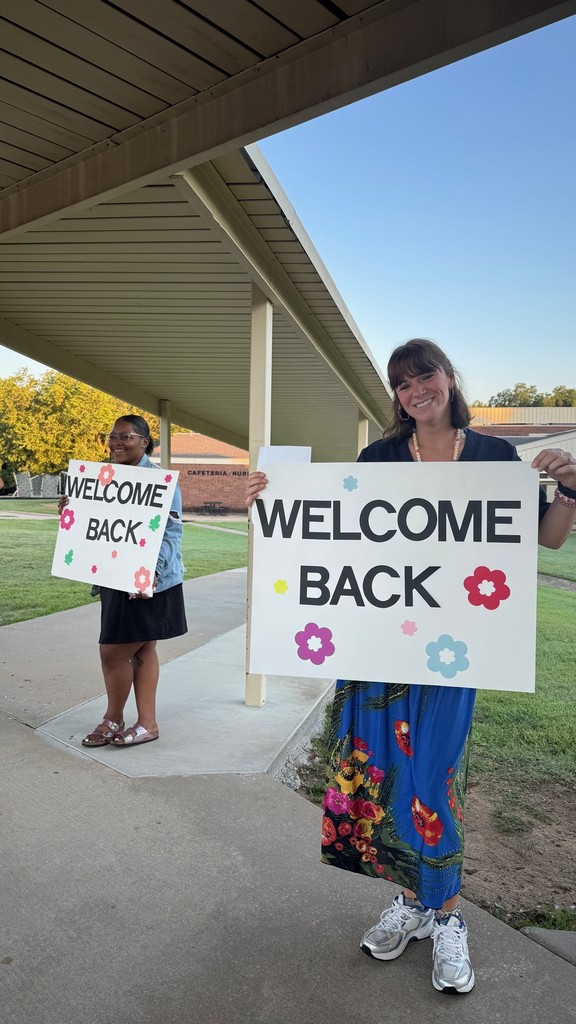 staff members with welcome sign