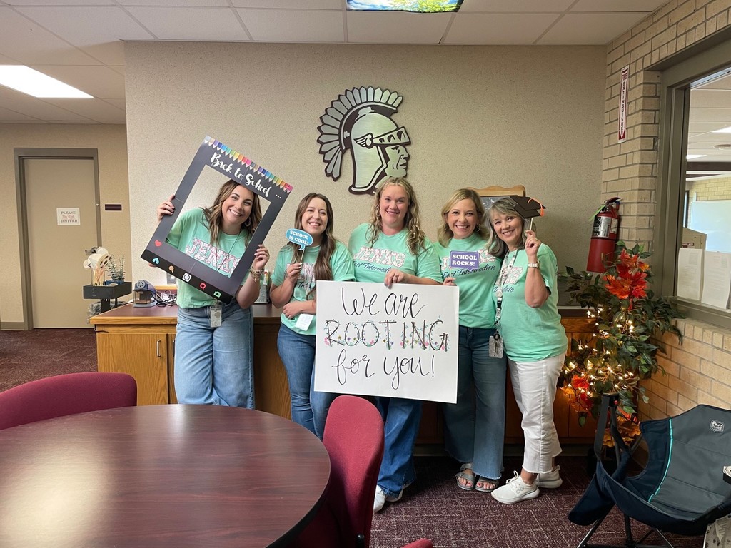 teachers with sign that says Rooting for you