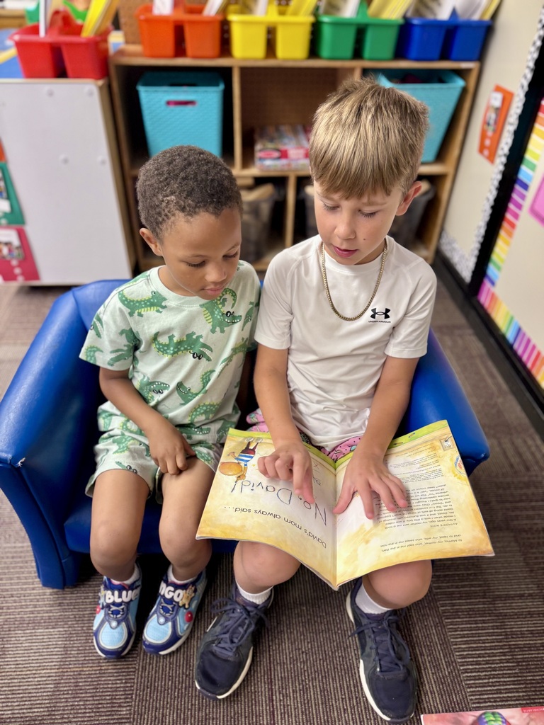 Students reading a book in classroom