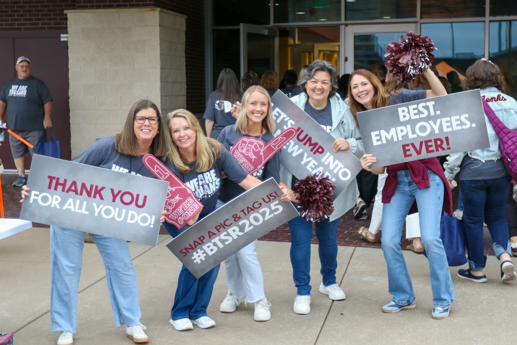 admins holding welcome signs