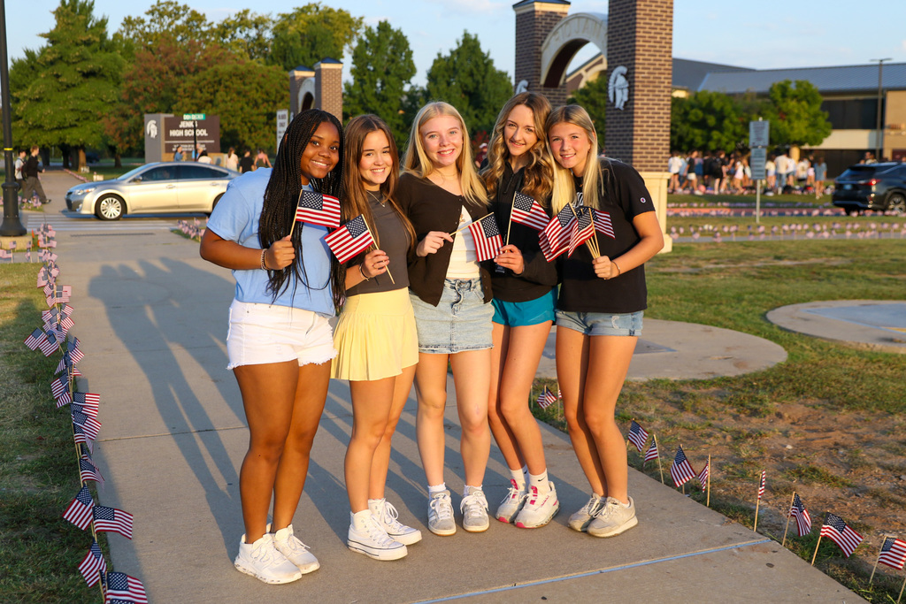 group of students posing with flags