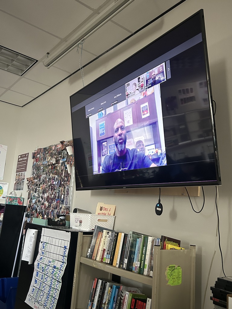 An image of a TV showing a zoom call with Alton Carter