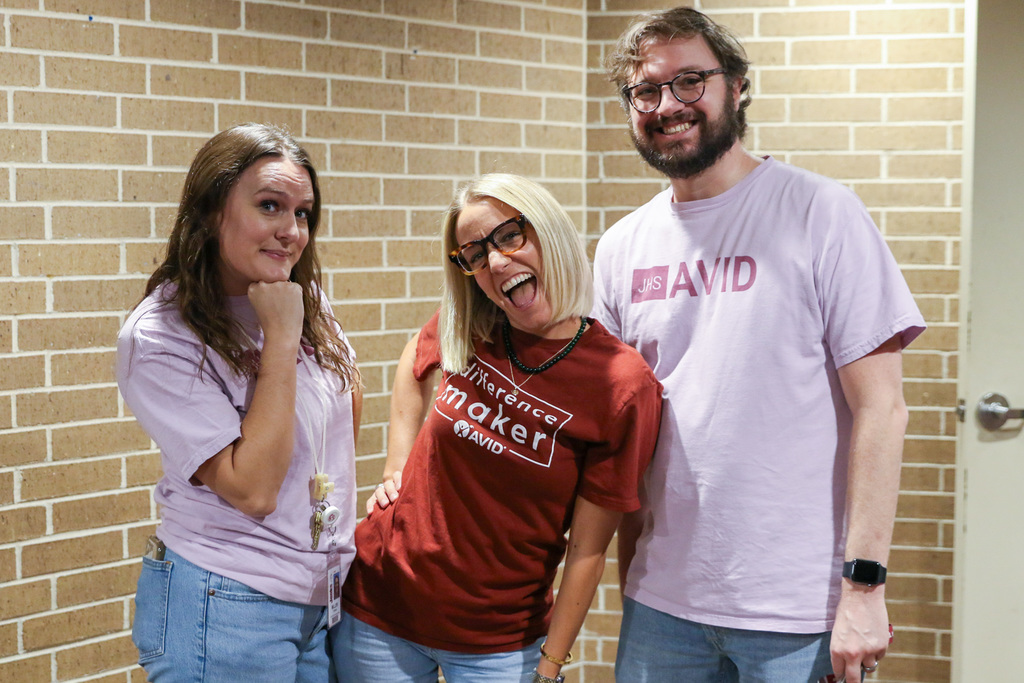 three AVID teacher posing for picture wearing AVID t-shirts