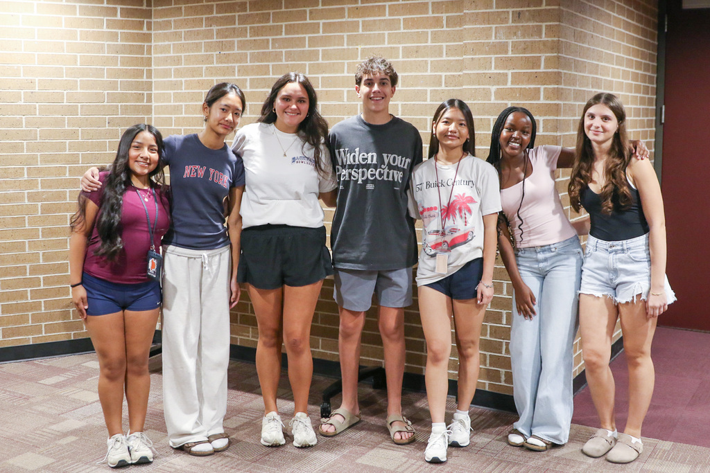group of AVID students with arms around each other smiling for photo