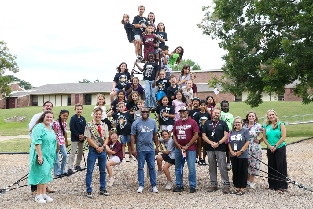 Mayor Nichols posing with student tour guides on East Elementary playground