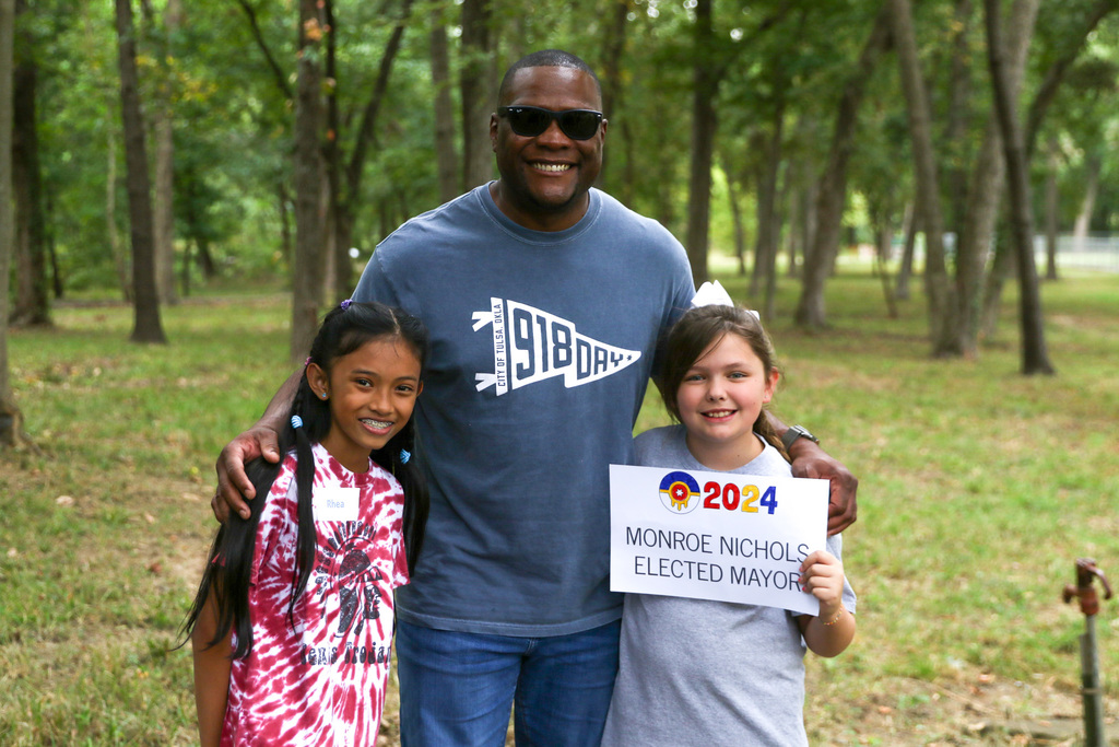 Mayor Nichols smiling for picture with two students