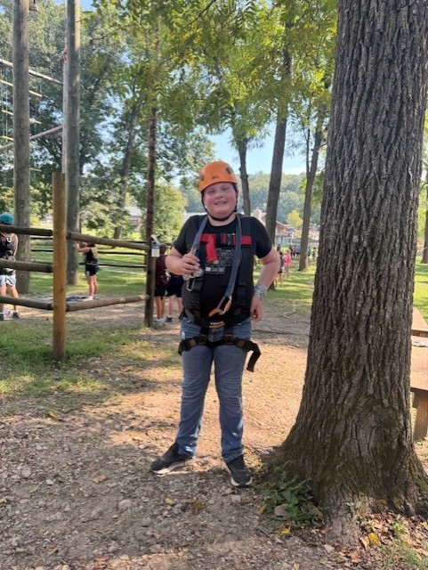 student ziplining at Jenks Wild