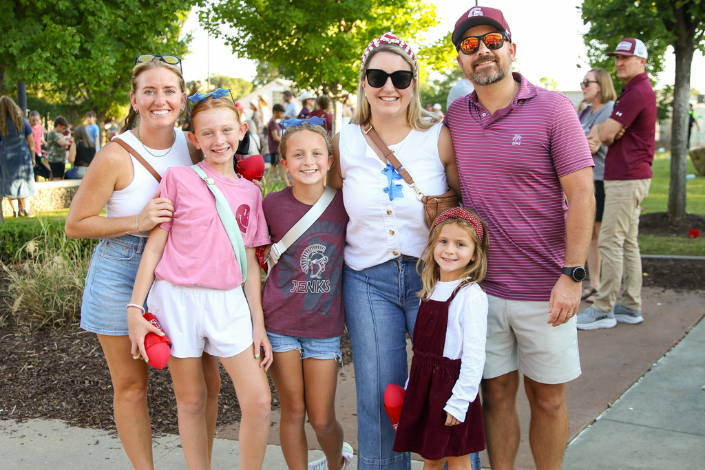 family of 6 all dressed in jenks colors smiling for a photo