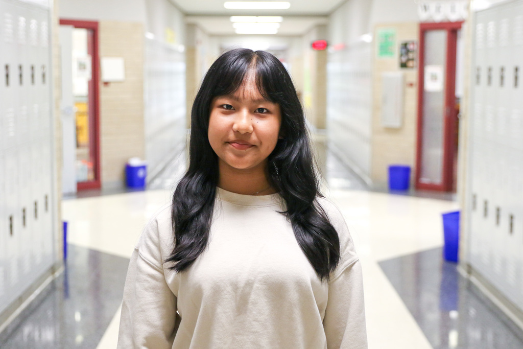 photo of Niang Kop standing alone in hallway of Jenks Middle School