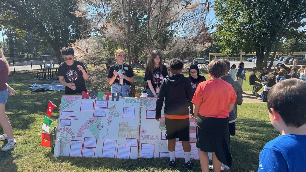 students learning from high schooler