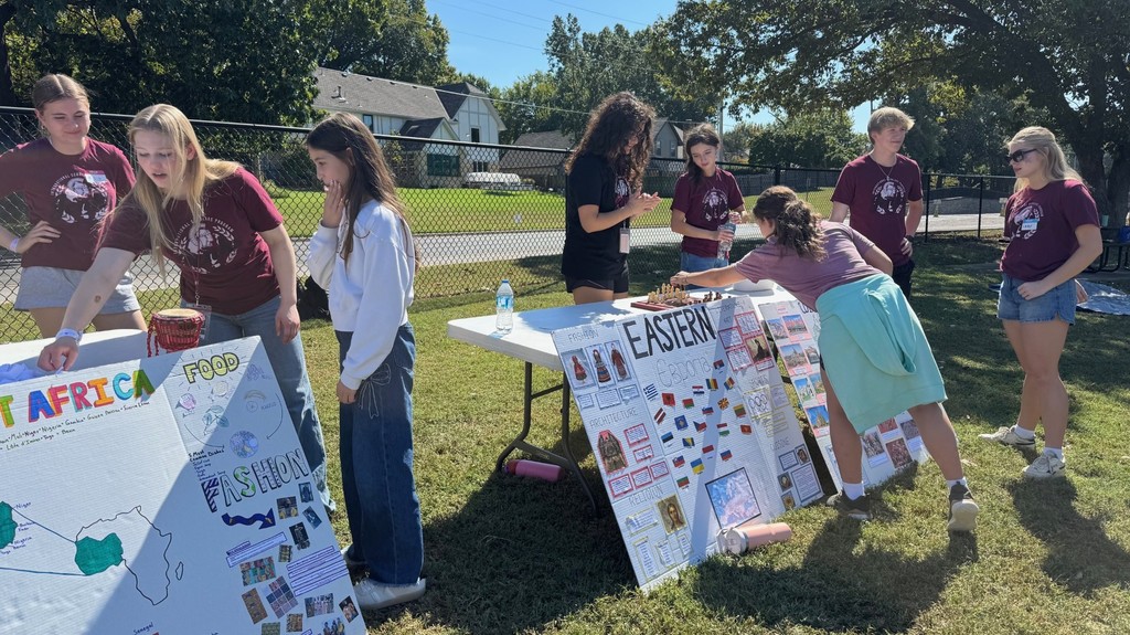 students learning from high schoolers