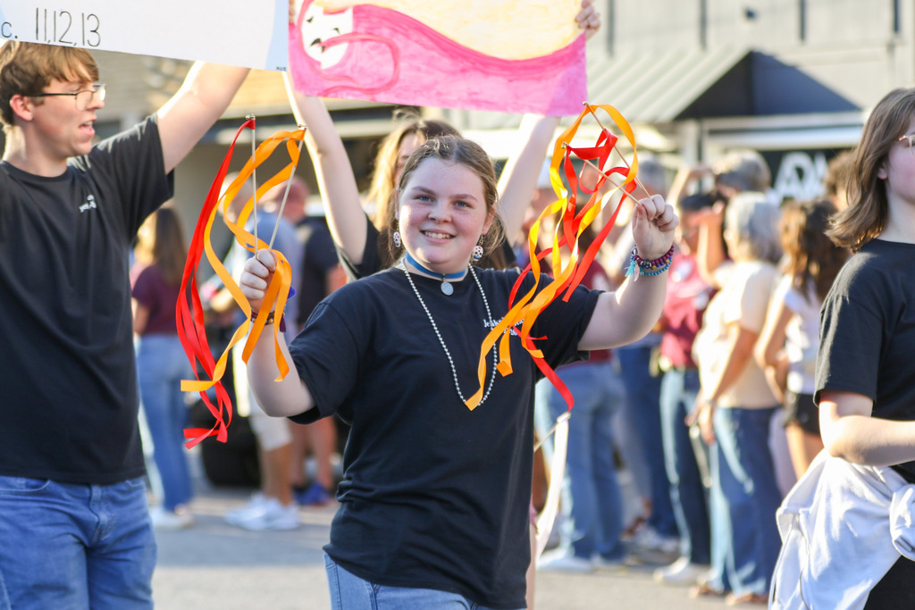 girl twirling ribbon and smiling at the camera