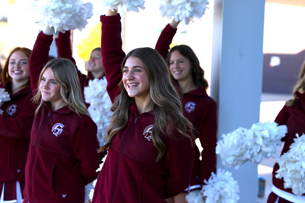 picture of pom girl with arm raised smiling during STUCO welcome in High School oval