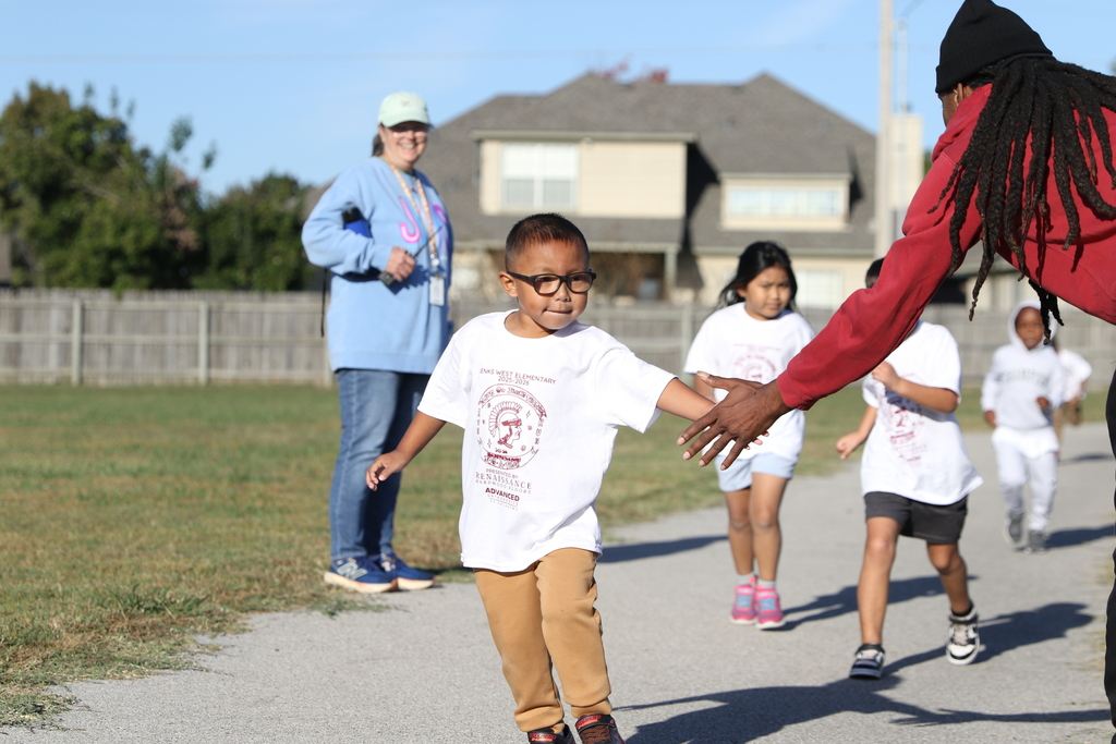 Student high-fives spectator at jog-a-thon