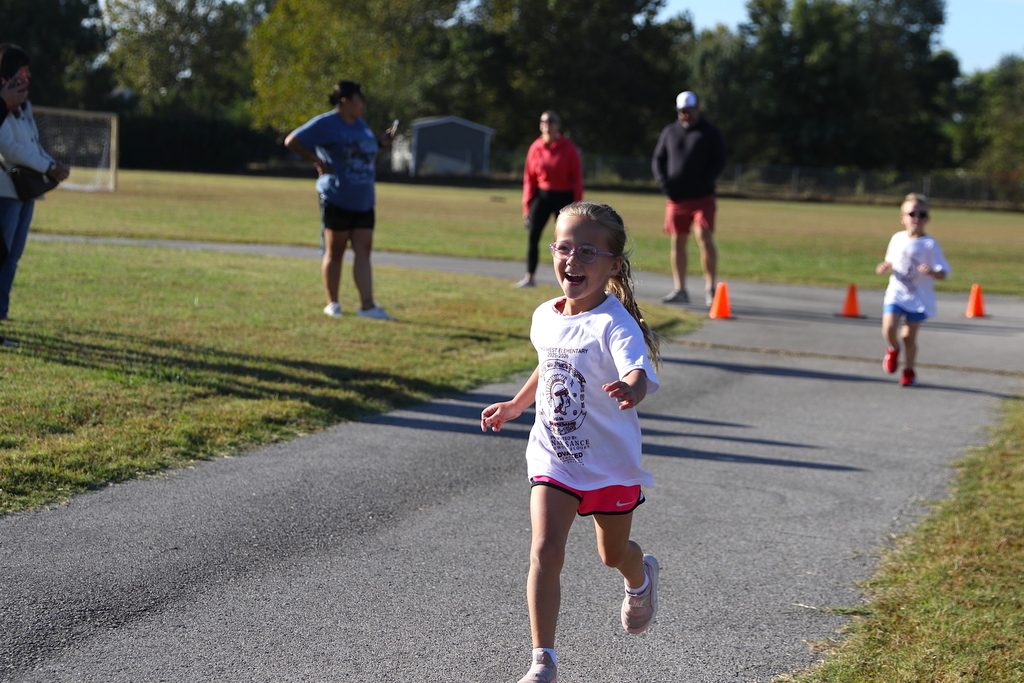 girl smiling and running during jog-a-thon