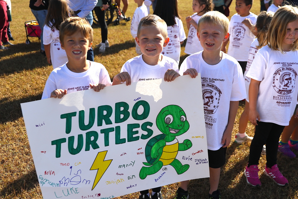boys holding class sign labeled "turbo turtles" during jog-a-thon