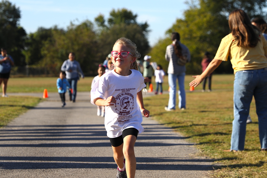 girl running with sun on her face during jog-a-thon