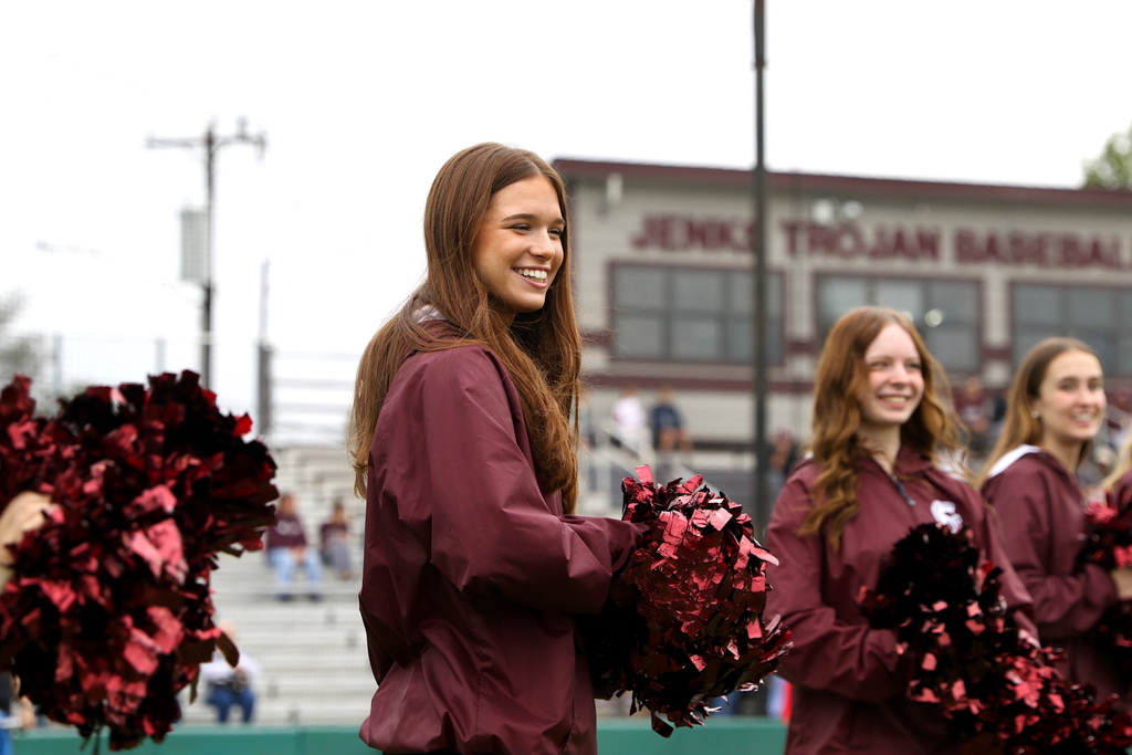 member of Jenks pom squad smiling during buddy baseball game