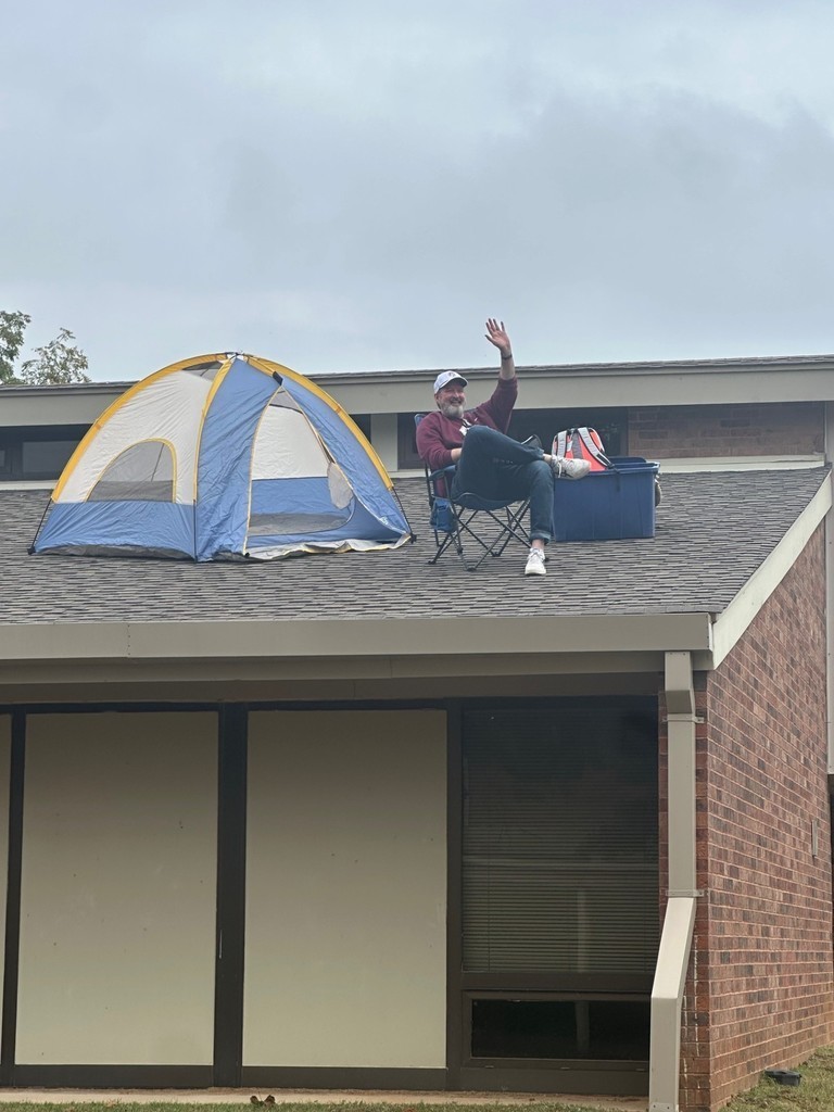Dr. Glaze on roof of school