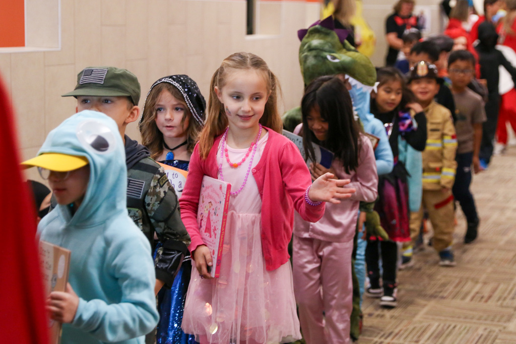 girl waving during the parade