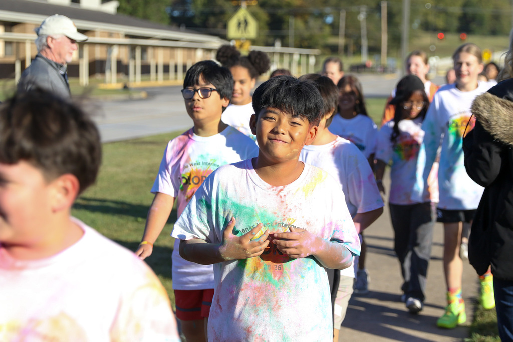 boy smiling at the camera when walking