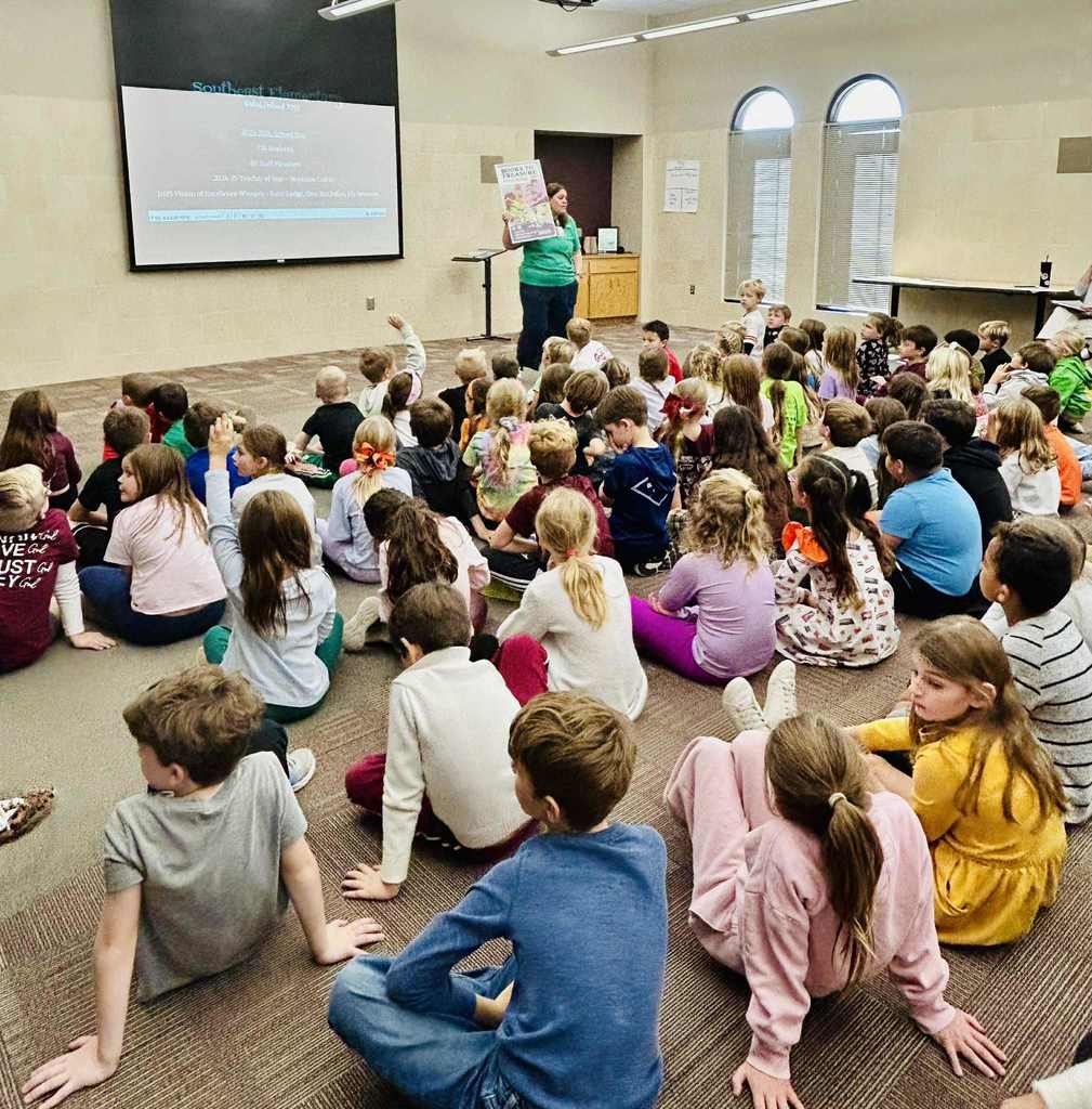 Group of second-graders listening to a speaker