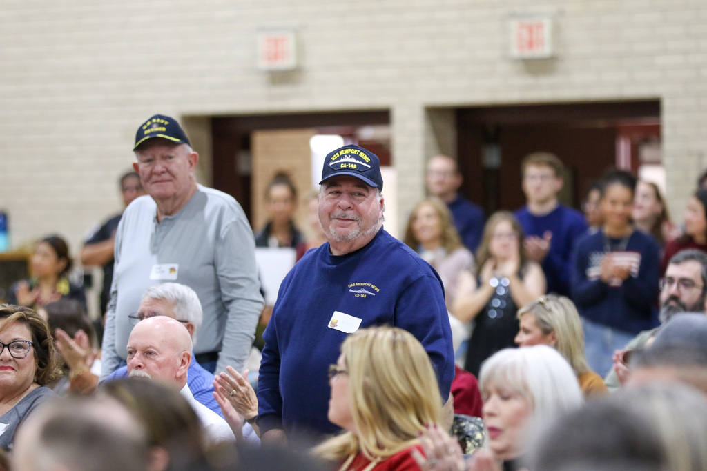 two veterans standing to be honored