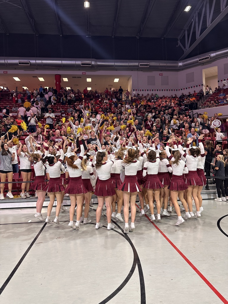 Jenks varsity pom squad celebrating state championship with cheering fans