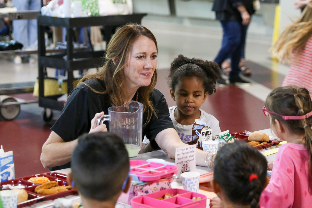 principal giving a student lemonade