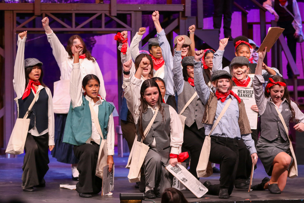 ensemble posing with their fists int the air