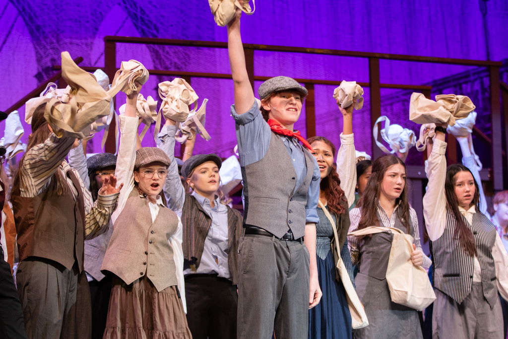 lead and thers holding up their paper bags