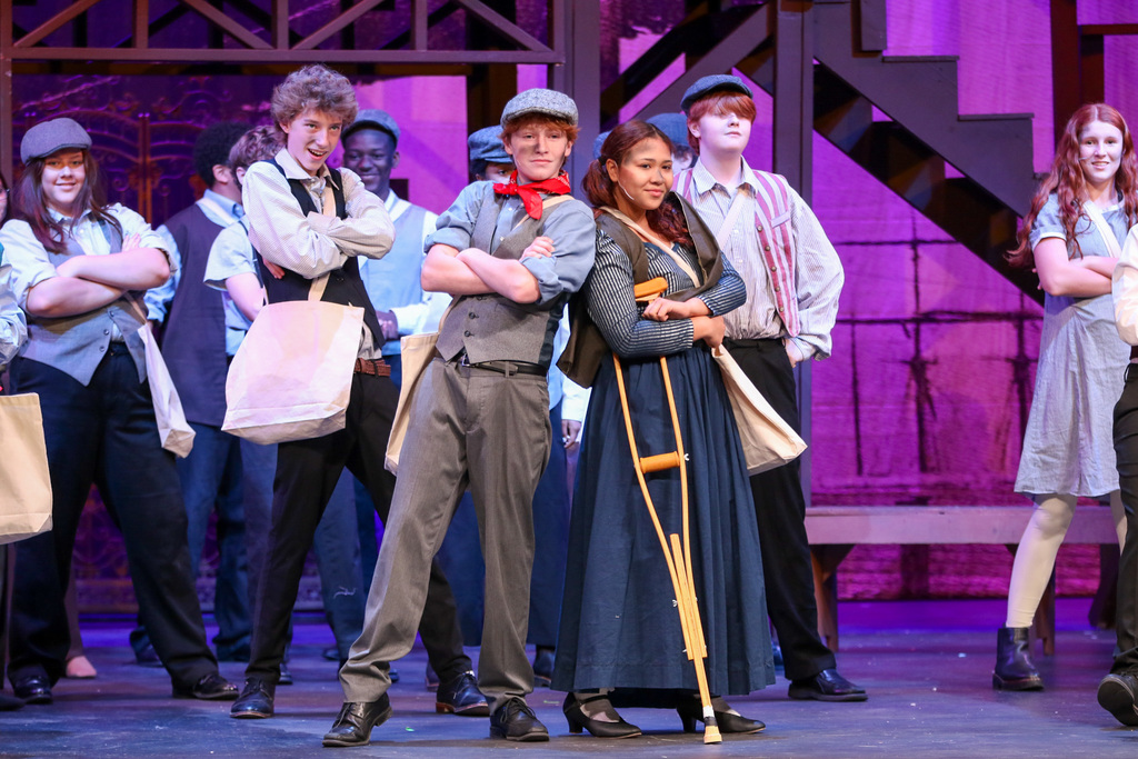 two leads with their arms cross posing