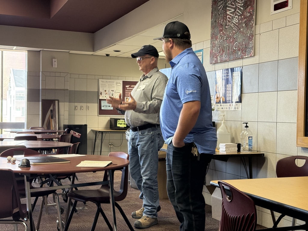 Two men speaking to group about their careers