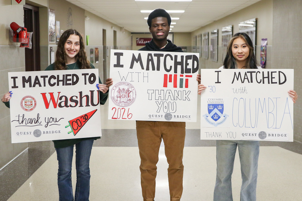 JHS senior students hold their match posters for the college scholarships they received via the QuestBridge National Match program
